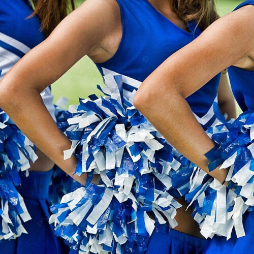 ChatGPT Close-up of cheerleaders in blue and white uniforms holding blue and white pom-poms, with hands on their hips.