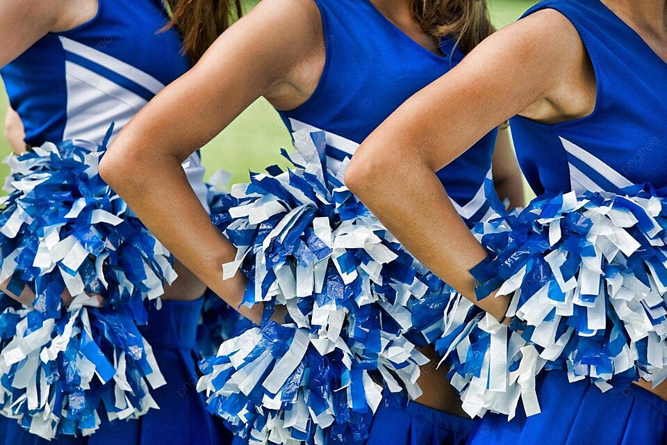 ChatGPT Close-up of cheerleaders in blue and white uniforms holding blue and white pom-poms, with hands on their hips.